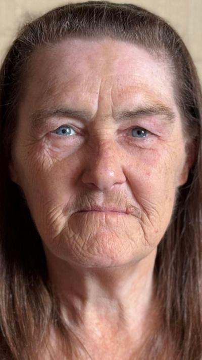 Close up elderly woman with long brown hair