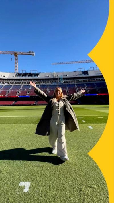 A woman stands on the field at Barca's new Nou Camp