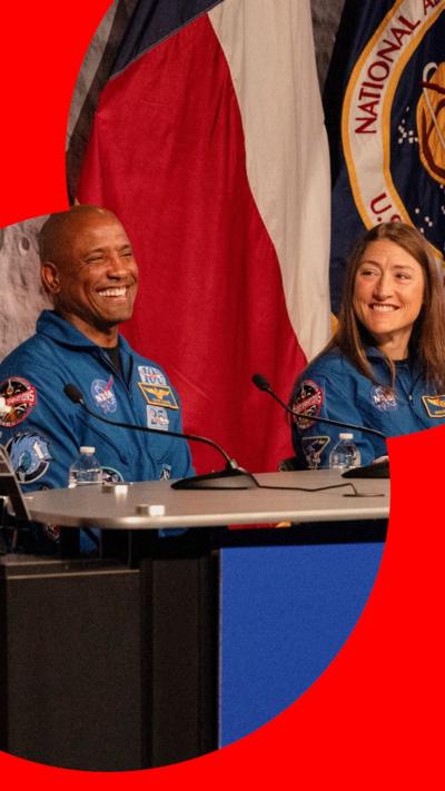 Victor Glover and Christina Koch smiling during a press conference