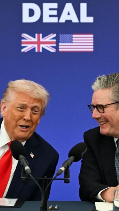 President Donald Trump and Sir Keir Starmer with a sign behind them that reads 'Deal'