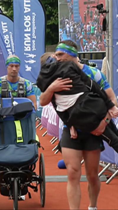 Kevin Sinfield carrying Rob Burrow over the finish line