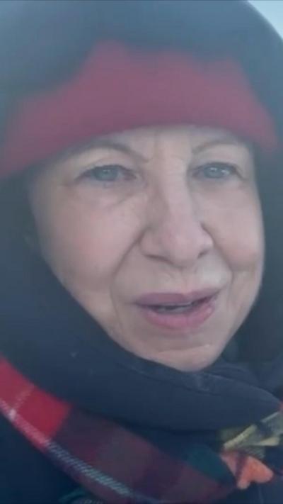 BBC journalist Lyse Doucet wearing red hat, hoodie and scarf