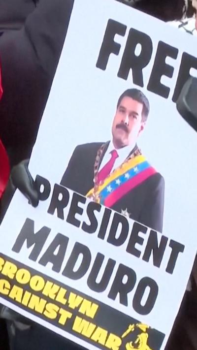 A sign saying free President Maduro is displayed.