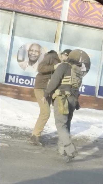 Two men face standing close to each other on a road