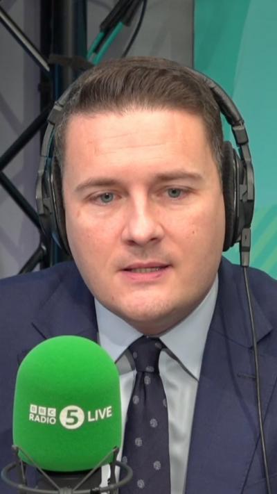 Wes Streeting wears a blue suit during a radio interview