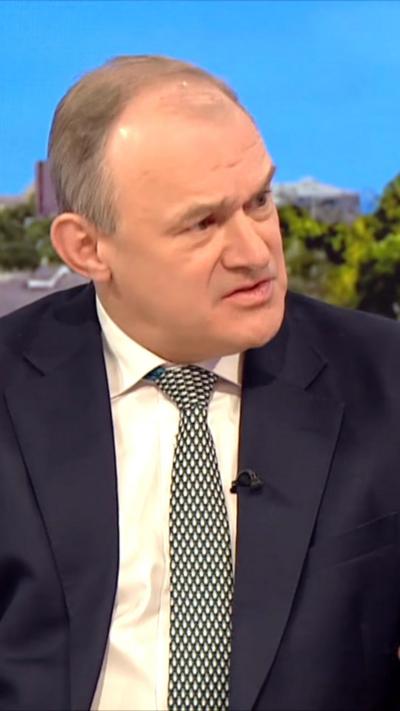 Leader of the Liberal Democrats, Ed Davey, wearing green and white tie, white shirt and black blazer