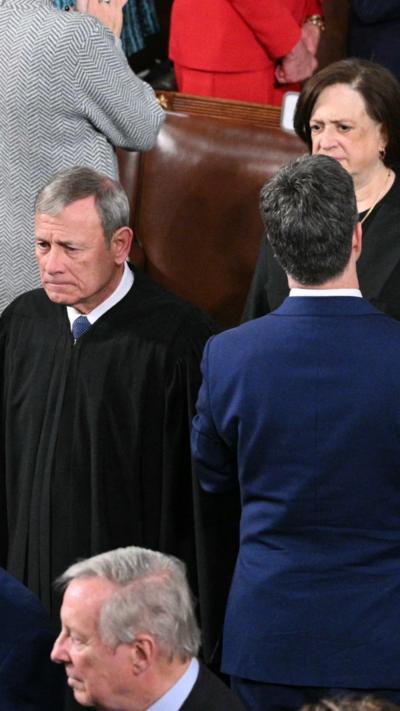 Supreme Court justices are entering the room.