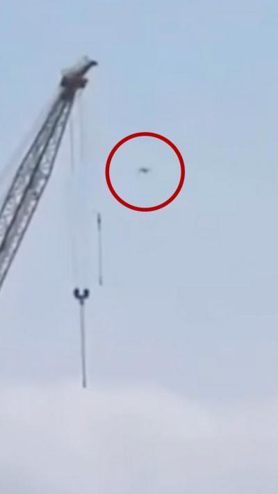 A drone circled in red in the sky