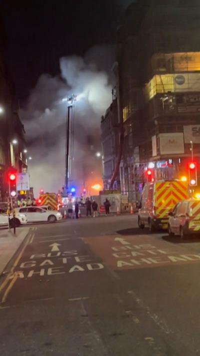 Union st fire from a distance with plumes of smoke and crowds of emergency services