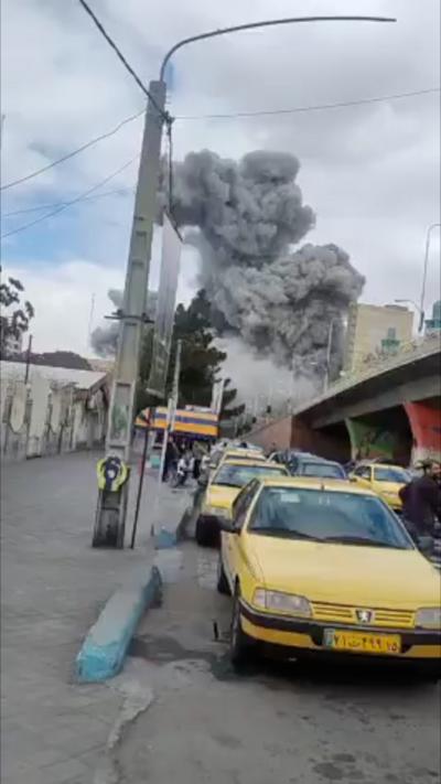 Large plume of smoke behind traffic
