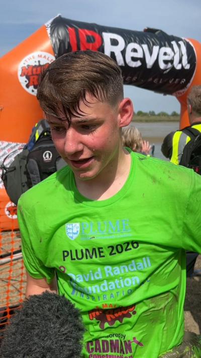 Albert Crates, 16, wears a green t-shirt by the finishing gate of the Maldon Mud Race 2026