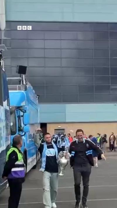 Two men with a trophy