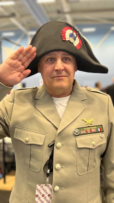Man dressed as Napoleon salutes.