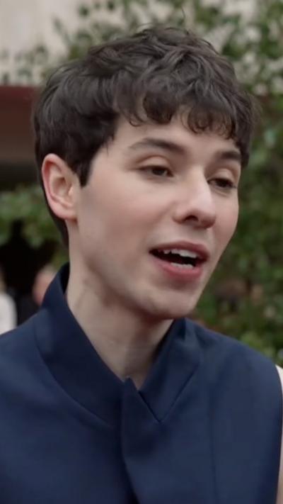 Close-up of Ellis Howard wearing sleeveless navy suit