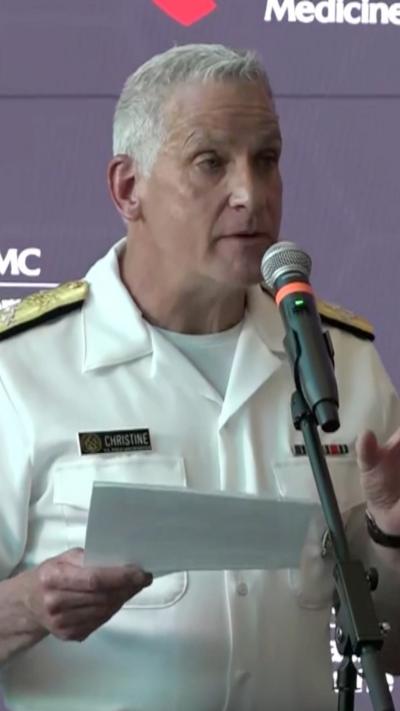 Admiral Brian Christine is talking to the press.