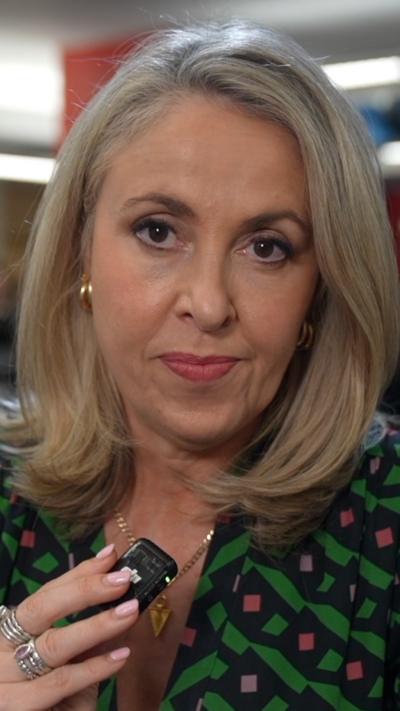 Sarah Smith is pictured holding a microphone.