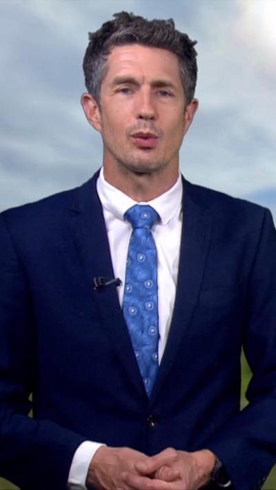 Chris speaking in front of weather screen