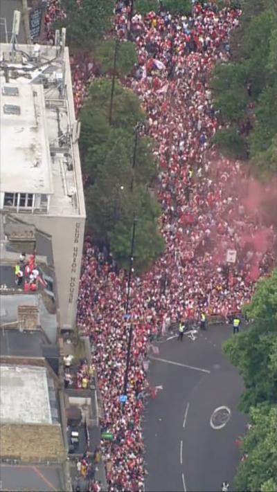 aerial footage shows large red arsenal parade crowd