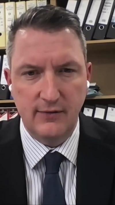 John Finucane in a suit and tie.