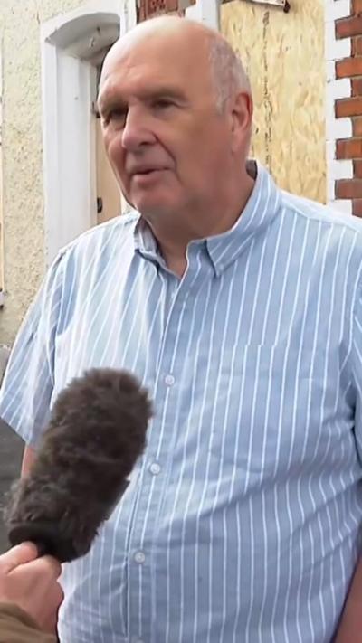 Reverend Brian Anderson being interviewed from Belfast, wearing light blue shirt