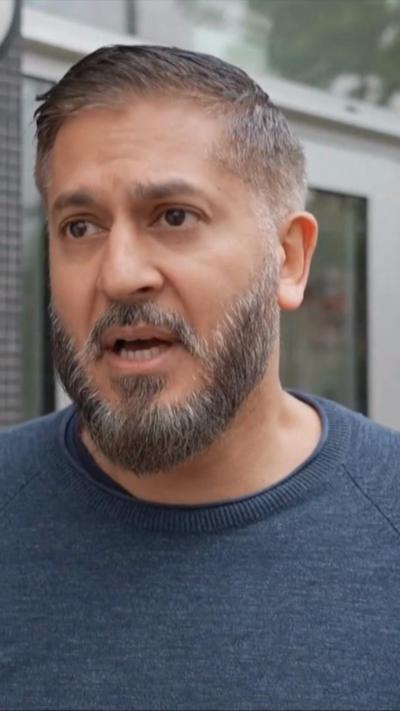 Akram speaking as he looks off camera