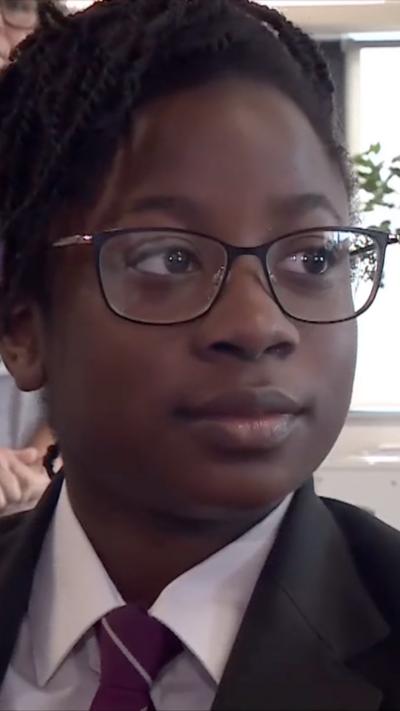 Young girl in glasses and school uniform