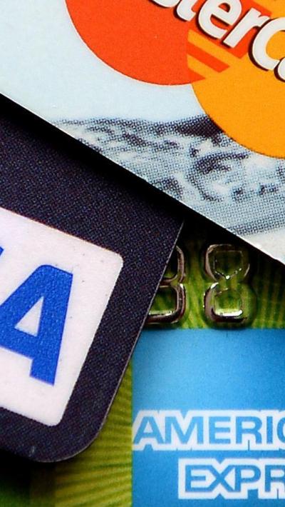 Three credit cards laid on top of each other