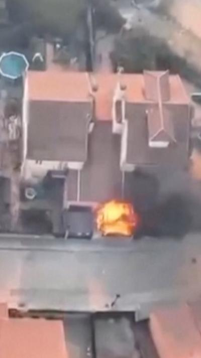 A house with a fire in the garden