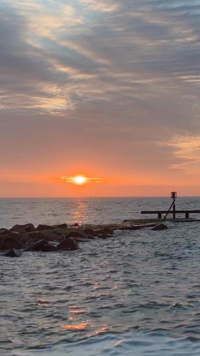 Sunrise on horizon over the sea of Suffolk coast