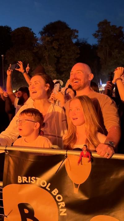 A family enjoys the Bristol Balloon Fiesta nightglow from the front row