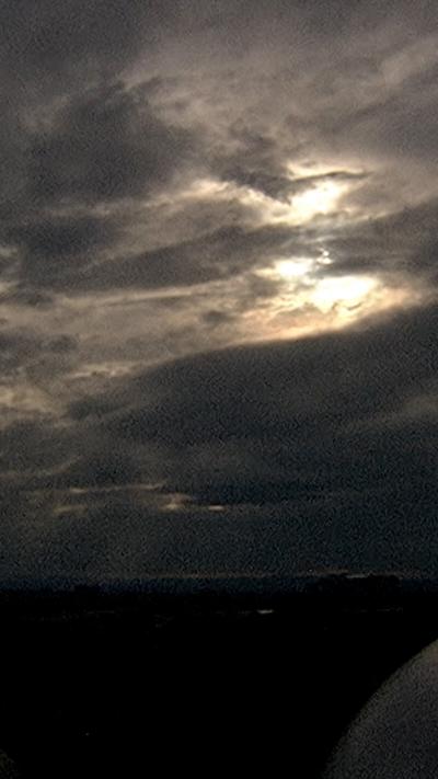 Dark cloudy sky with sun peaking out