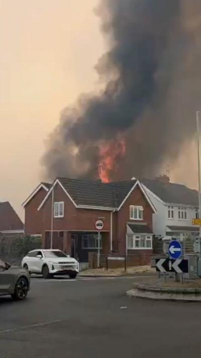 House on fire in front of a roundabout
