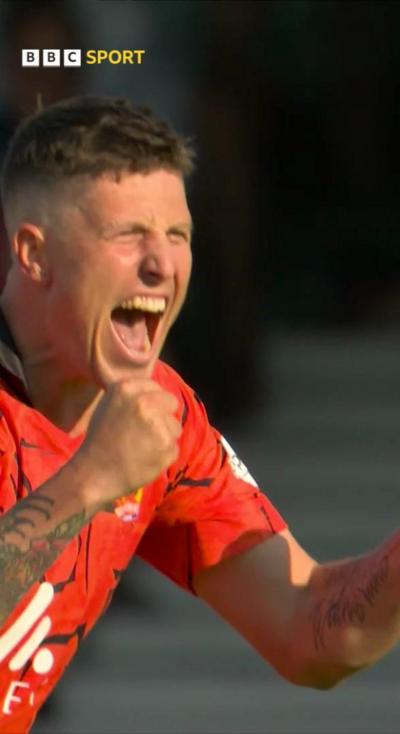 Brydon Carse after taking a wicket