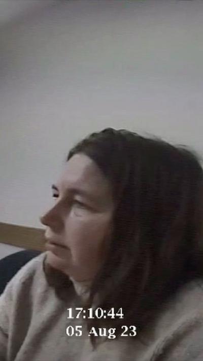 Erin Patterson sitting at a table in police station