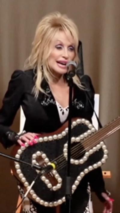 Dolly Parton in Kentucky with a black guitar
