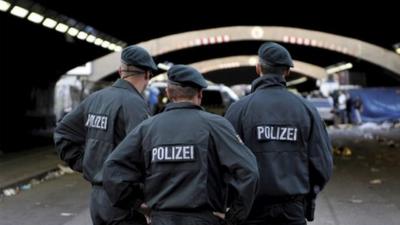 Police officers stand in front of tunnel