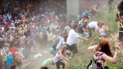 Revellers rush up a hill