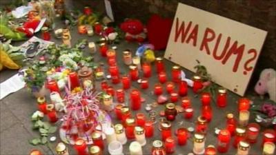 A poster among tributes at the Duisburg stampede site asks "Why?"