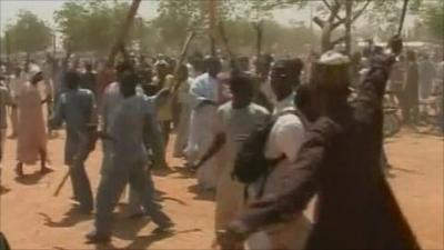 Protesters holding sticks