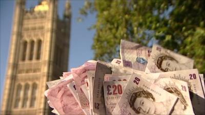 £20 notes in front of Parliament building