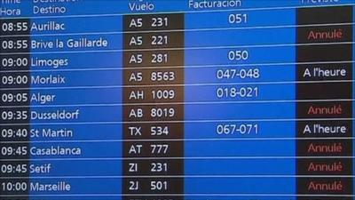 Airport departure board shows flight cancellations