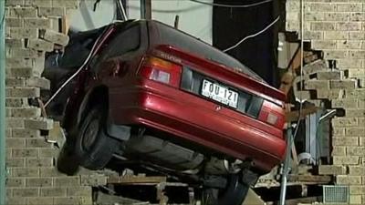 Car embedded in house