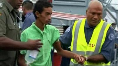 One of the surviving teenagers helped off a boat
