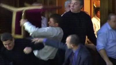 Man raising chair to throw