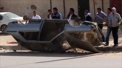 Protesters turning over car