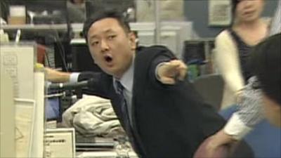 Office worker points as earthquake hits