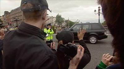 Man waving at Queen