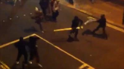 Youths charge police