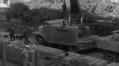 German officials supervise construction of the Berlin Wall