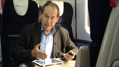 BBC Technology Correspondent Rory Cellan-Jones testing mobile phone signals on a train from Cardiff to London